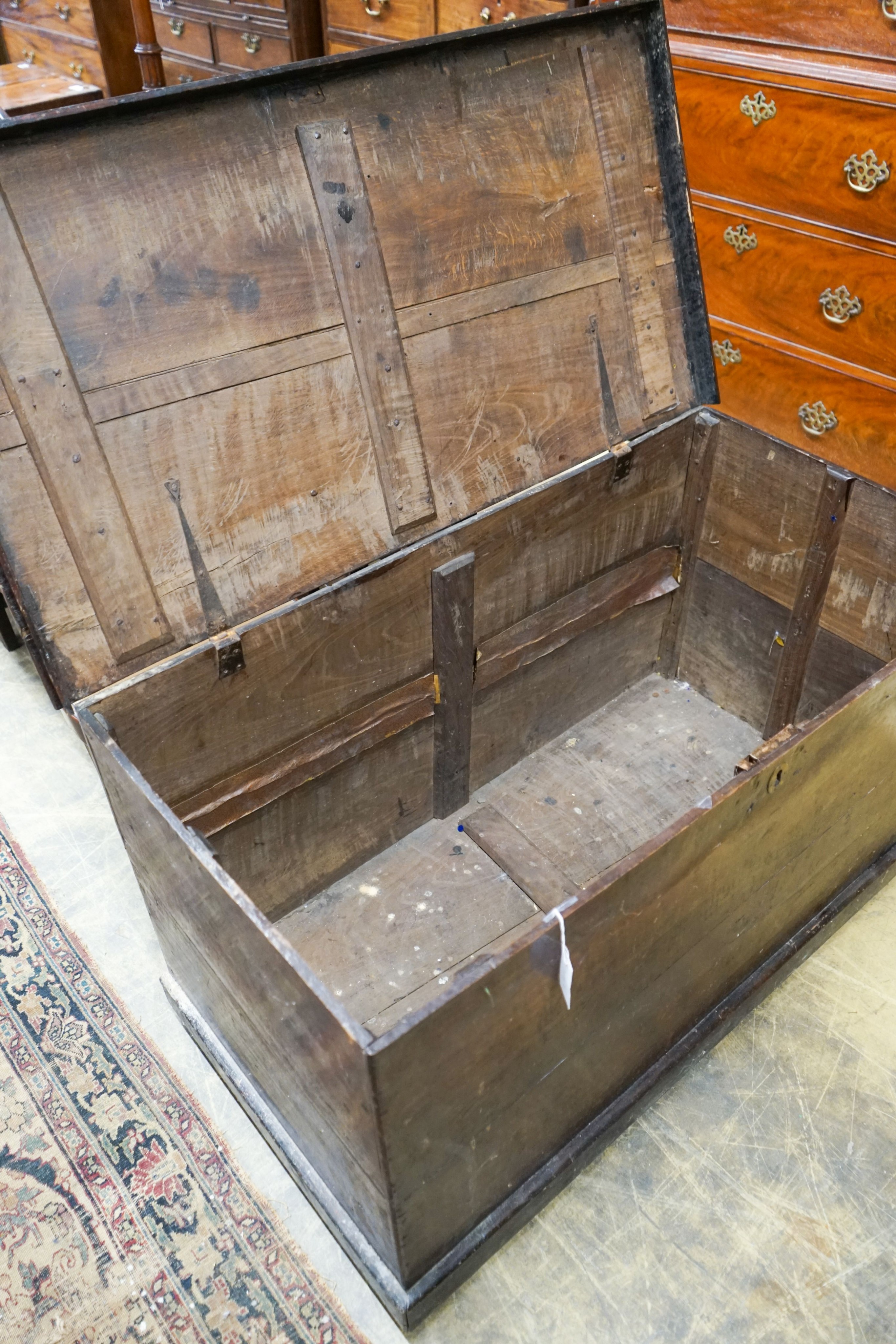 An early 19th century rectangular oak trunk, length 116cm, depth 61cm, height 66cm